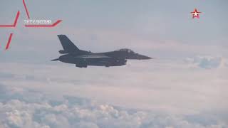 Exclusive footage Su27 fighter drives NATO F16 away from Shoigu aircraft [upl. by Elleinnad747]